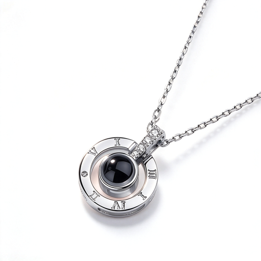 100 languages projection necklace with a Roman numeral pendant and dark center accent, displayed on white.