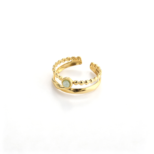 Angled view of an 18k gold-plated open ring featuring a beaded band set with a natural green crystal stone.