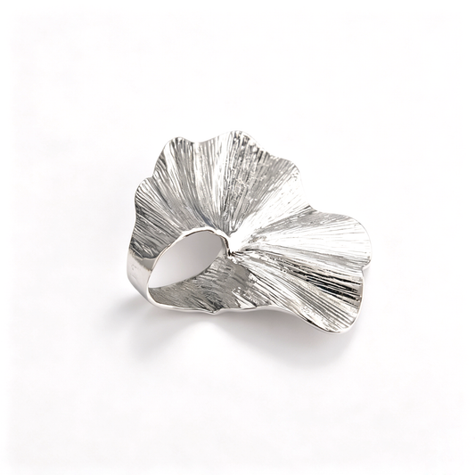 Top-down detail of the silver-toned oversized ginkgo leaf statement ring with textured finish.