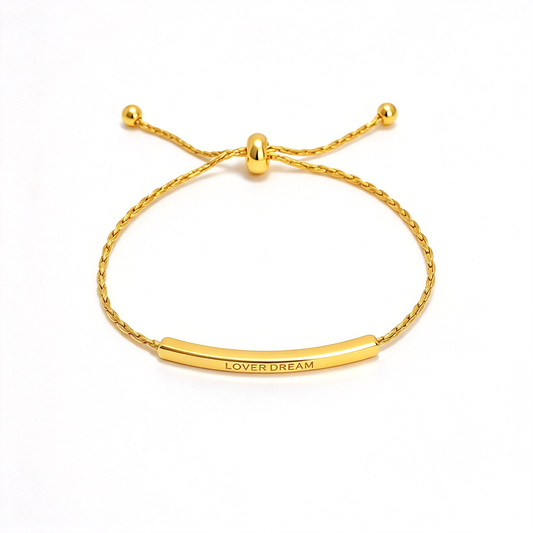 Adjustable bar bracelet with a curved engraved bar and sliding chain shown on a white background.