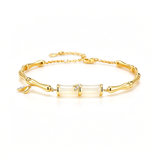 Gold-tone bamboo-style bracelet displayed from the front with two central segments and small leaf charms.