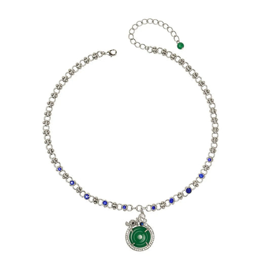 Full layout of Ever P. Art Deco inspired green crystal donut pendant necklace with sapphire rhinestones isolated on white.