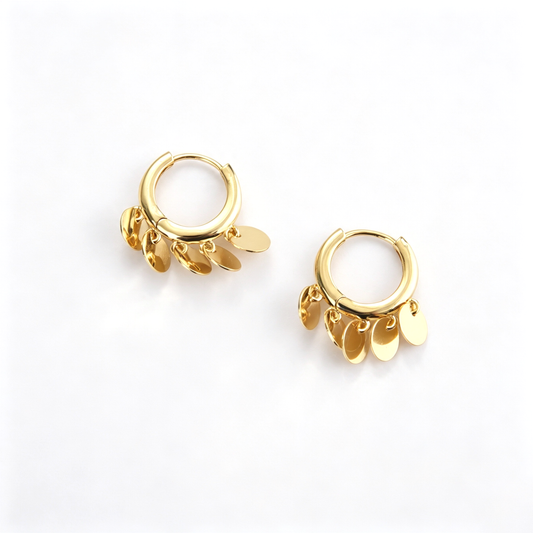 Close-up view of the round hoops and overlapping dangling disc charms