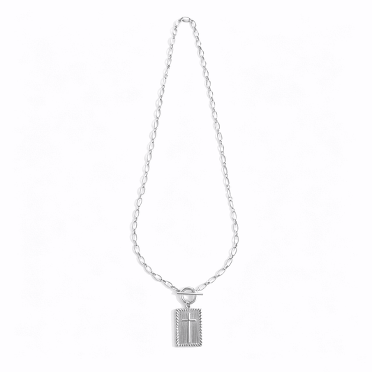Side profile of a silver cross necklace for women, showcasing the depth of the 3D cube pendant.