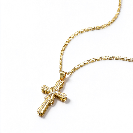 Angled view of a cross pendant showing its curved decorative details and fine chain