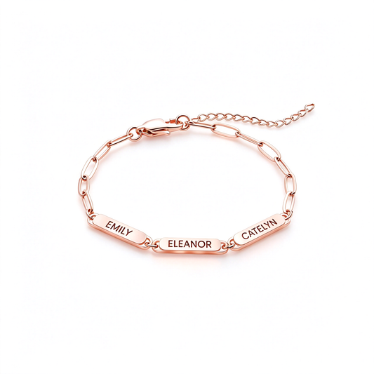 Custom name bar bracelet with three engraved name plates and an adjustable chain on a white background.