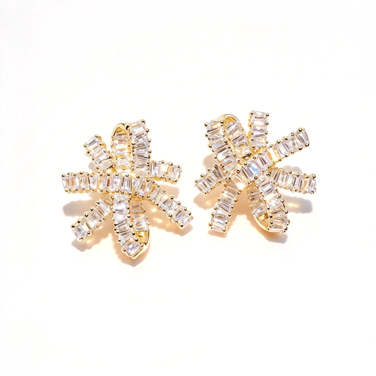Gold-tone bow knot earrings displayed as a pair, showing the sculpted loops and sparkling decorative details.