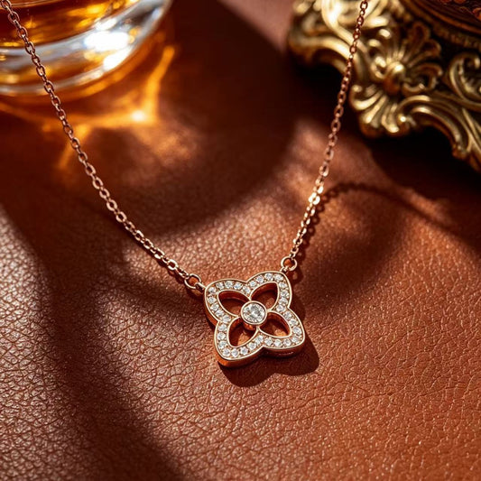Four-petal flower pendant necklace styled on a warm brown textured surface with golden decorative accents.
