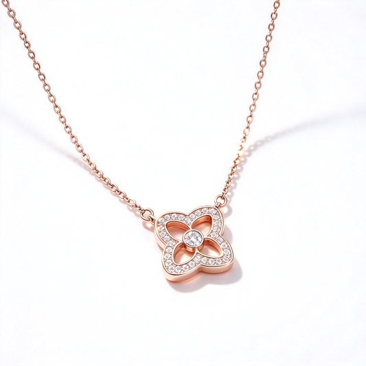 Four-petal flower pendant necklace with a sparkling border and a round center detail on a clean white background.