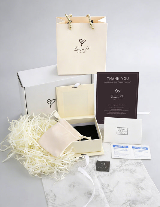 Complete Ever P. jewelry packaging set including a cream gift bag, premium box with ribbon, microfibre pouch, and thank you card.
