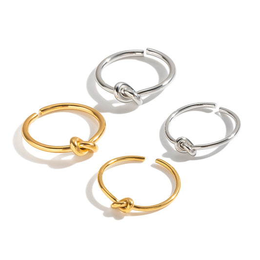 Four open knot rings displayed together in gold-tone and silver-tone finishes.