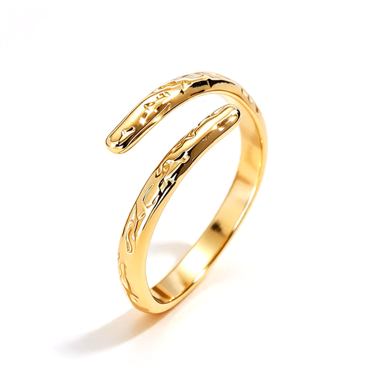 Gold-tone open band ring with an irregular sculpted surface on a white background