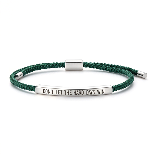 Personalized engraved rope bracelet in pink with a silver-tone bar reading “DON’T LET THE HARD DAYS WIN.”