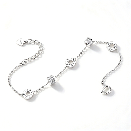 Silver-tone bracelet displayed diagonally with Roman numeral circles and textured barrel accents.