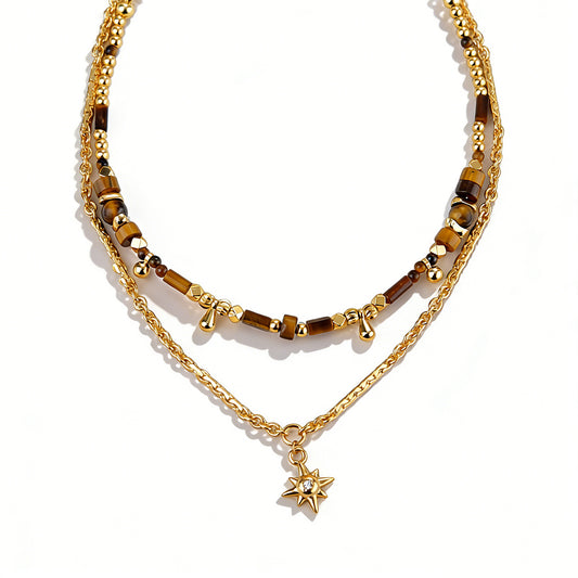 Ever P. tiger eye necklace featuring a geometric gold pendant with black agate.