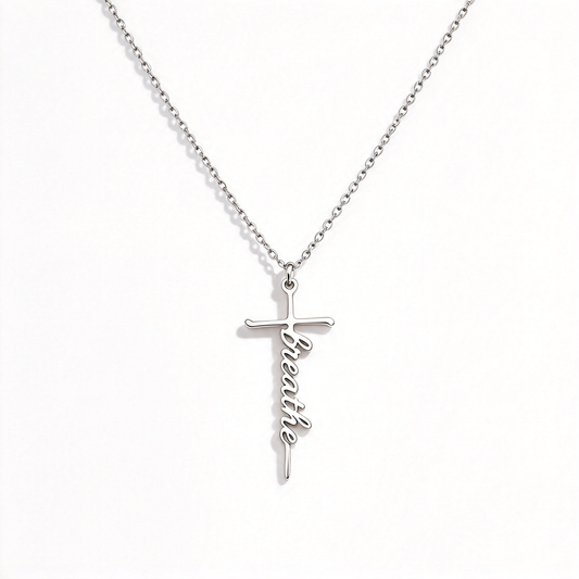 Personalized word cross necklace with script lettering on a fine chain, shown against a white background.