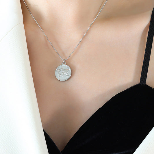 Silver-tone round world map necklace displayed against a black V-neck top.