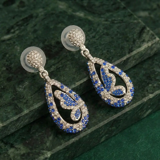 Close-up of the marquise-cut blue stone earrings in a butterfly silhouette.