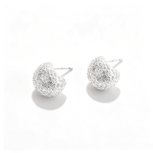 Close-up of Ever P. vintage style hammered silver earrings, focusing on the sophisticated molten-metal texture.