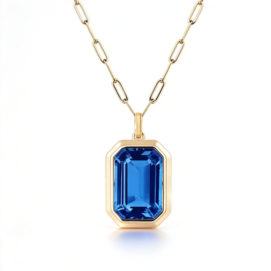Geometric cut pendant necklace with a blue rectangular centerpiece and linked chain.