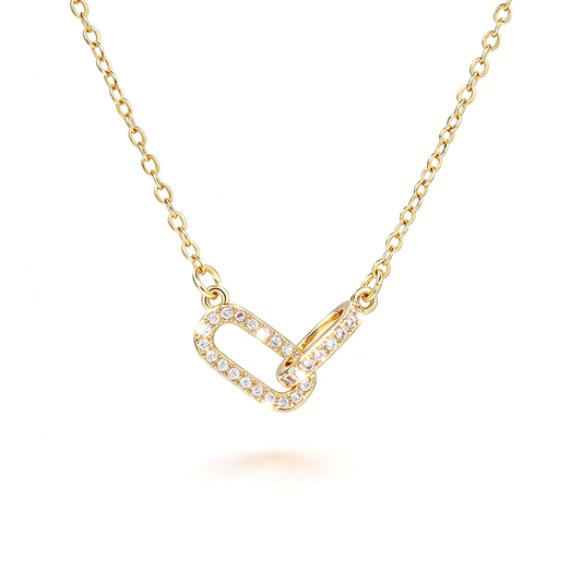 Gold-tone geometric link pendant necklace with an interlocking pendant and delicate chain.