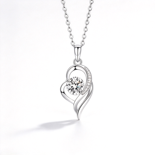 Heart-shaped pendant necklace with a sparkling center and flowing openwork details on a white background.