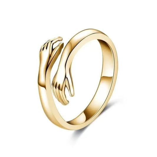 Gold-tone adjustable ring with facing hand details against a white background