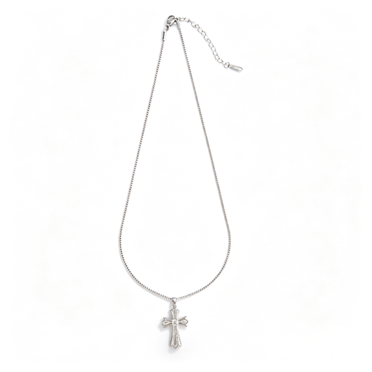 Full view of the silver-tone cross necklace with pendant, lobster clasp, and extender chain.