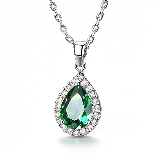 Green pear-shaped pendant necklace featuring a faceted centerpiece surrounded by decorative stones.