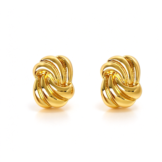 Gold-tone sculptural knot stud earrings with a bold interwoven design and smooth curved details.