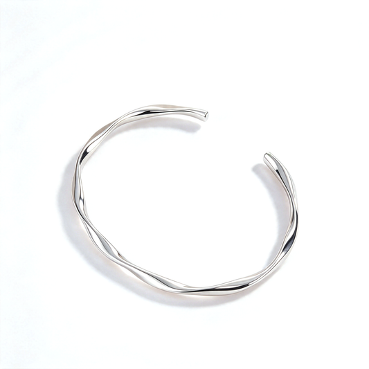 Silver tone open cuff bracelet shown alone against a white background