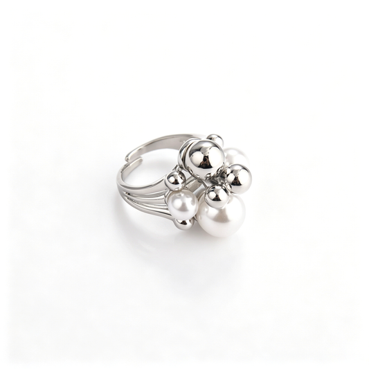 Side angled view of silver cluster ring showing pearl and metallic sphere arrangement with adjustable band.