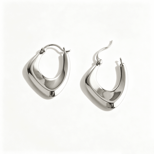 Ever P. silver hoop earrings with a modern twisted cross design in a polished silver finish.