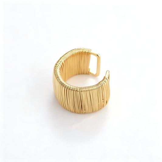 Wide cuff bracelet shown from the front, highlighting the open ends and vertical ribbed texture