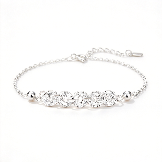 Silver-tone bracelet featuring five linked coin motifs, a fine chain, and an adjustable extension.
