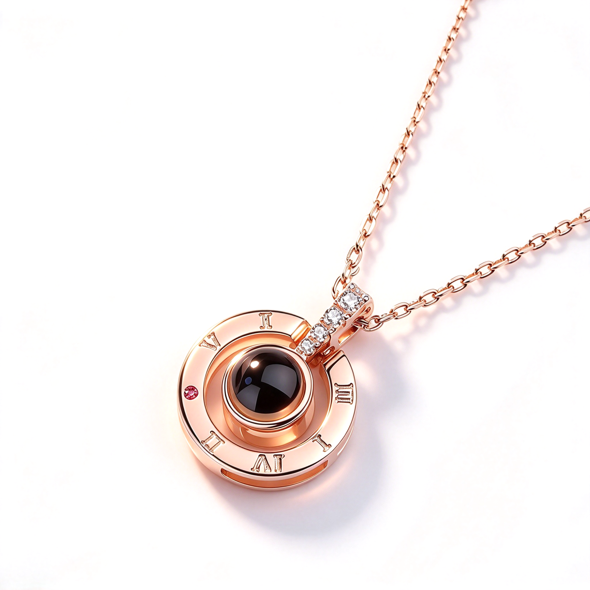 Close-up of the round pendant showing Roman numeral markings, a dark center accent, and the attached chain.