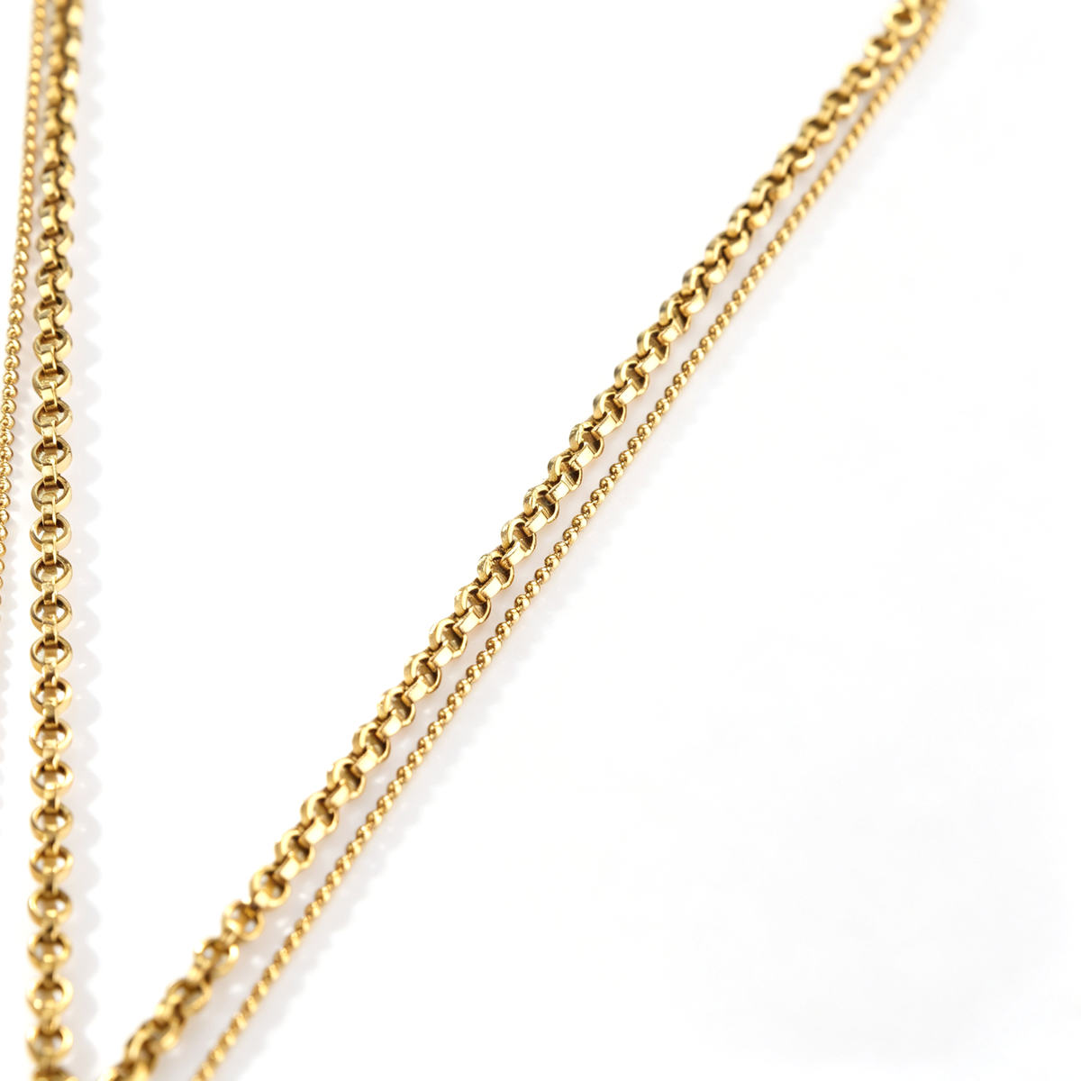 Detailed view contrasting the fine ball chain and thick Rolo chain strands of the 18k gold-plated necklace.