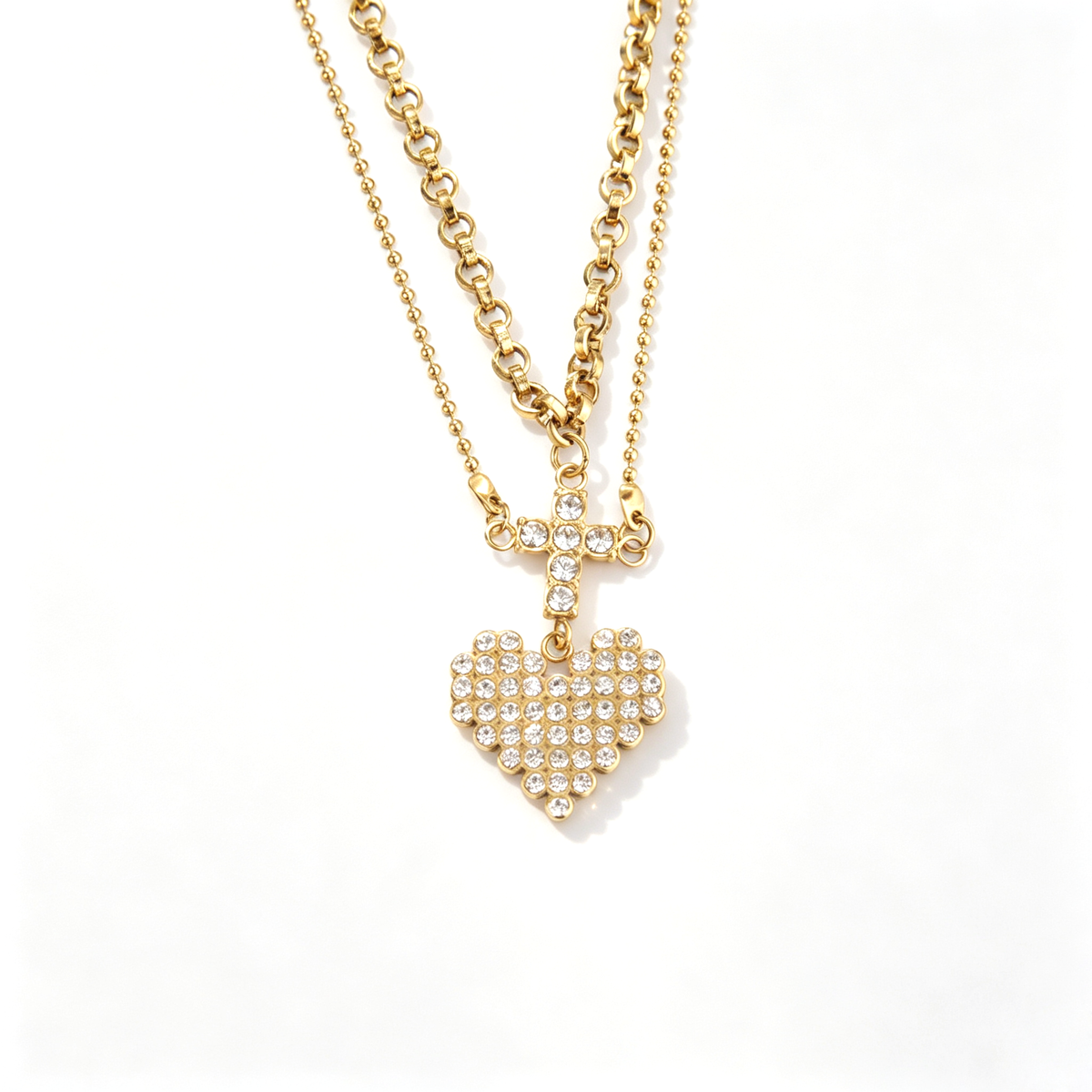 Frontal view showcasing the connected crystal cross connector and sparkling heart pendant layout.