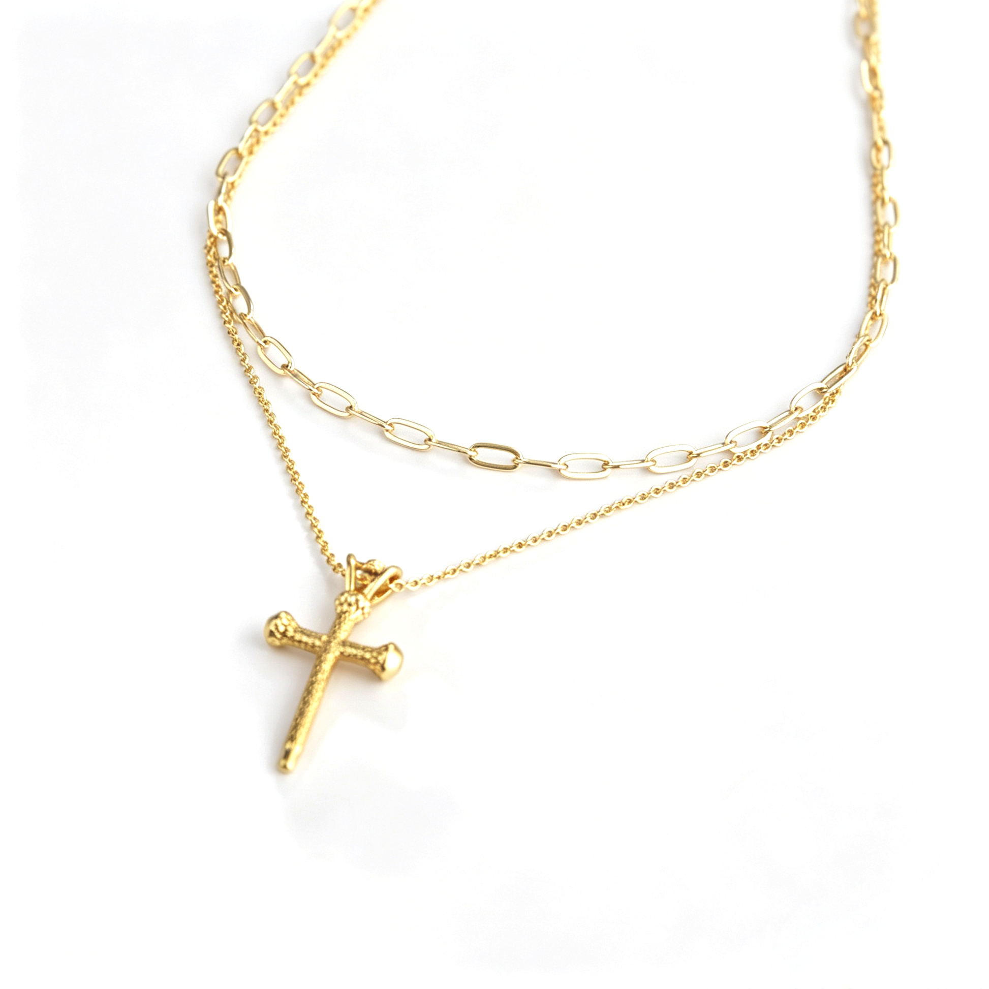 Side angle view showing texture of 18k gold plated cross pendant and chain texture
