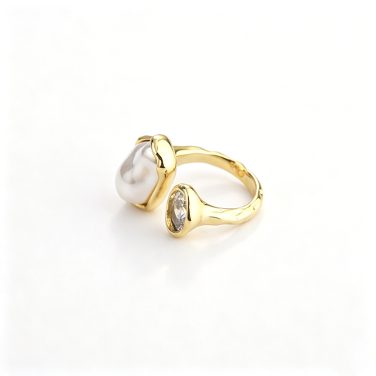 Side view of an 18k gold-plated open ring with a textured band, irregular pearl, and zirconia stone.