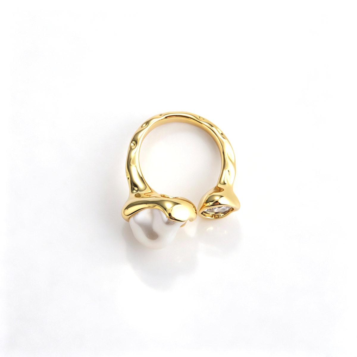 Top-down view of the gold adjustable bypass ring showing the molten texture and dual settings.