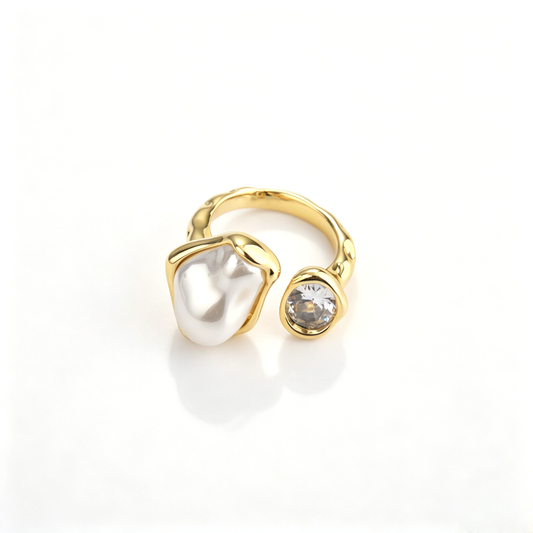 Frontal view of 18k gold-plated open ring featuring an irregular pearl and a brilliant cubic zirconia.