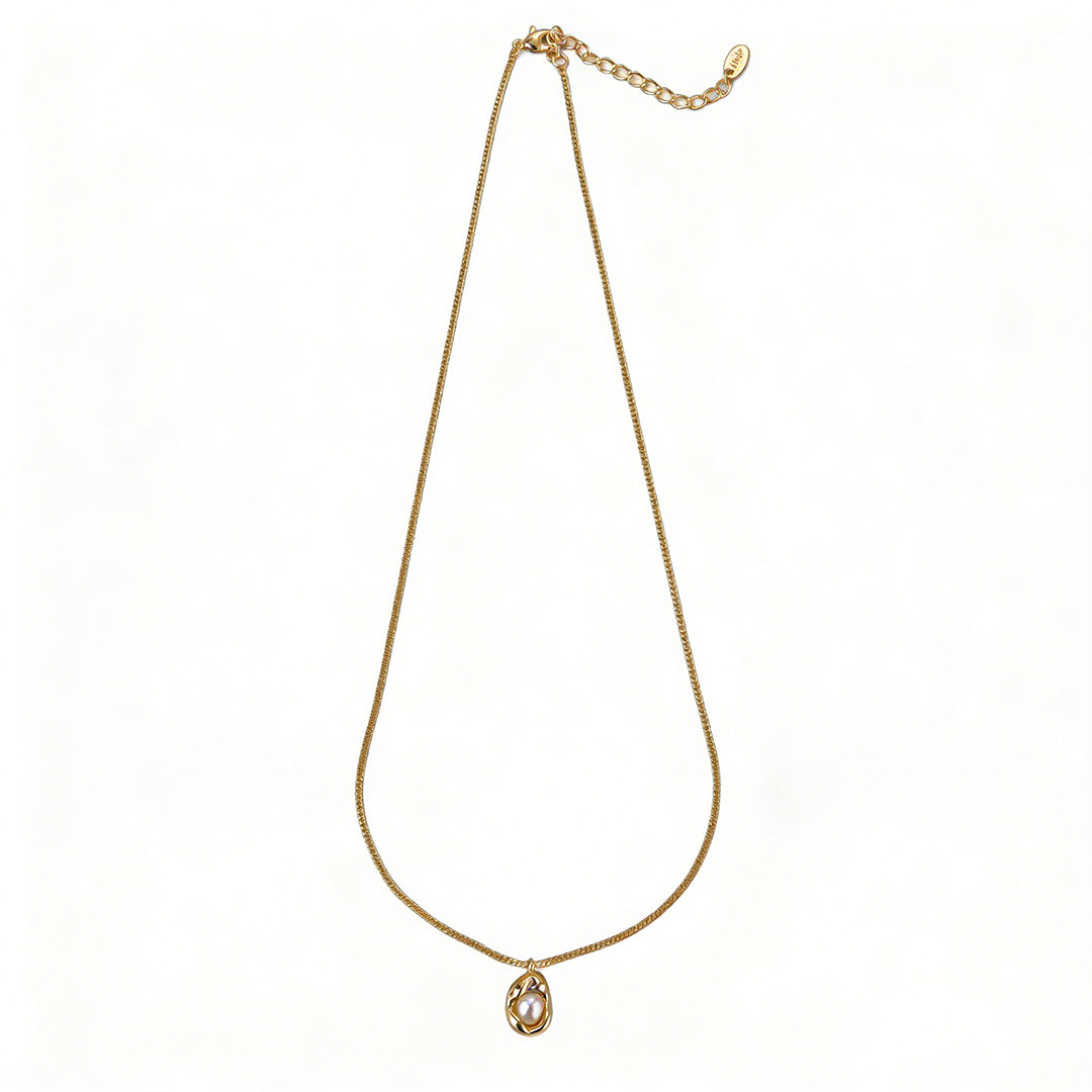 Close-up of an 18k gold plated necklace with lustrous natural freshwater pearls.