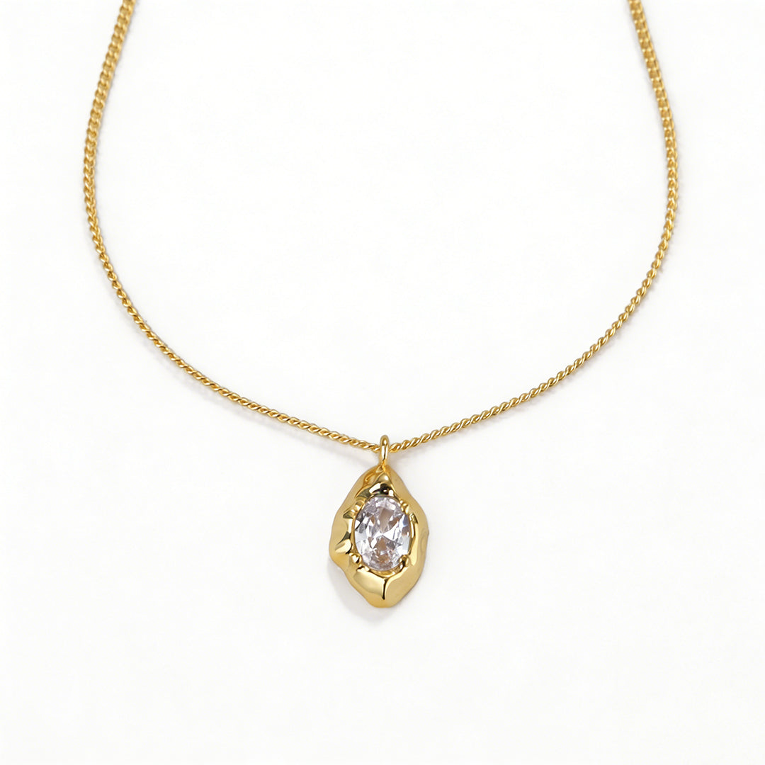 Close-up of an 18k gold plated necklace featuring a classic pear-shaped teardrop pendant.