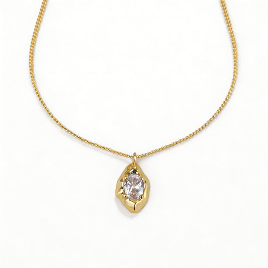 Close-up of an 18k gold plated necklace featuring a classic pear-shaped teardrop pendant.