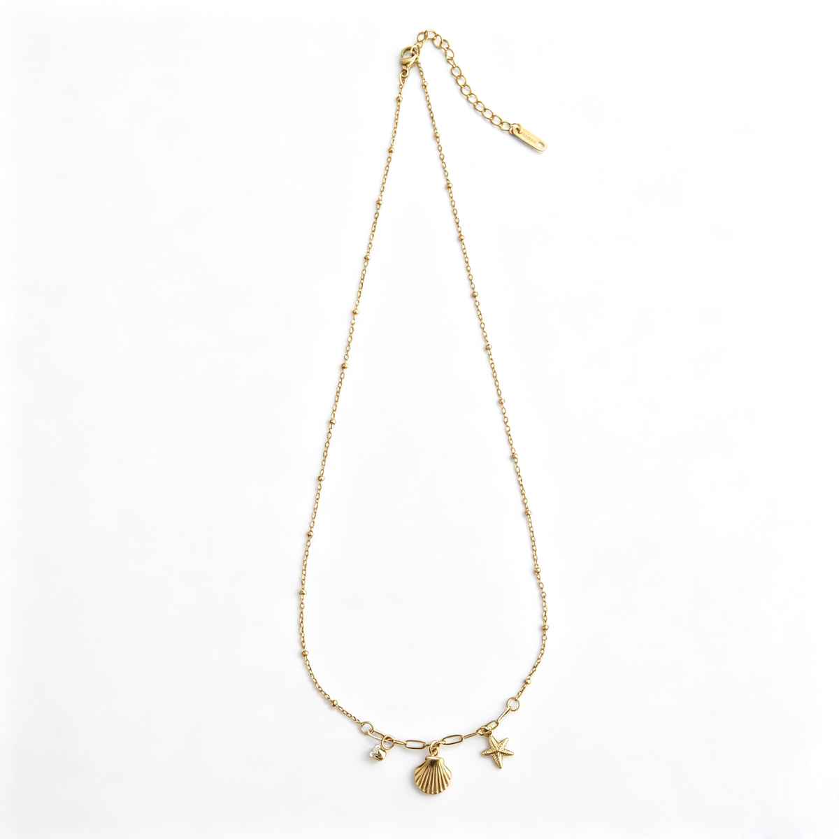 Full layout of the 18k gold-plated satellite chain necklace with dangling ocean-themed charms.
