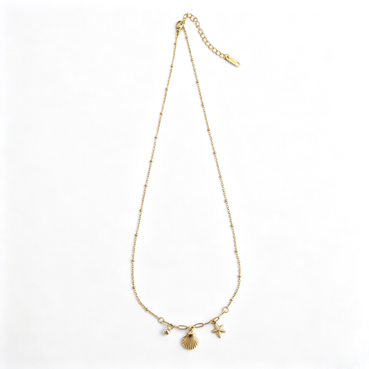 Full layout of the 18k gold-plated satellite chain necklace with dangling ocean-themed charms.