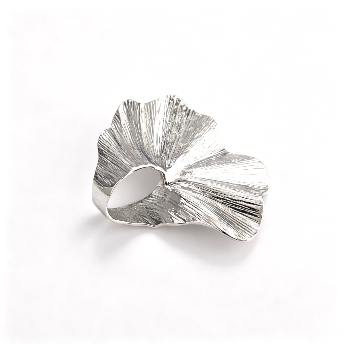 Top-down detail of the silver-toned oversized ginkgo leaf statement ring with textured finish.