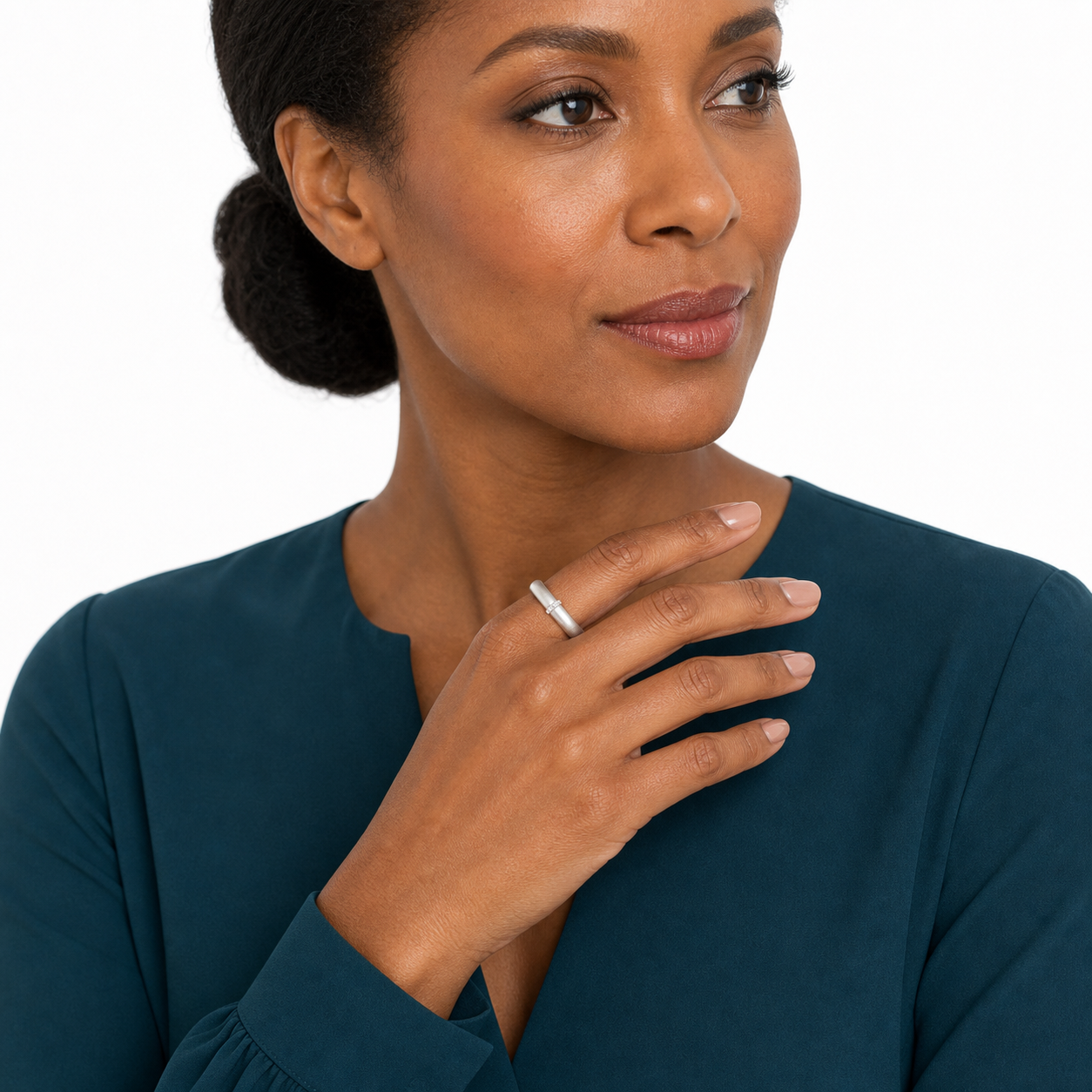 Black woman in a deep teal blouse wearing a matte silver-tone adjustable zircon statement ring.