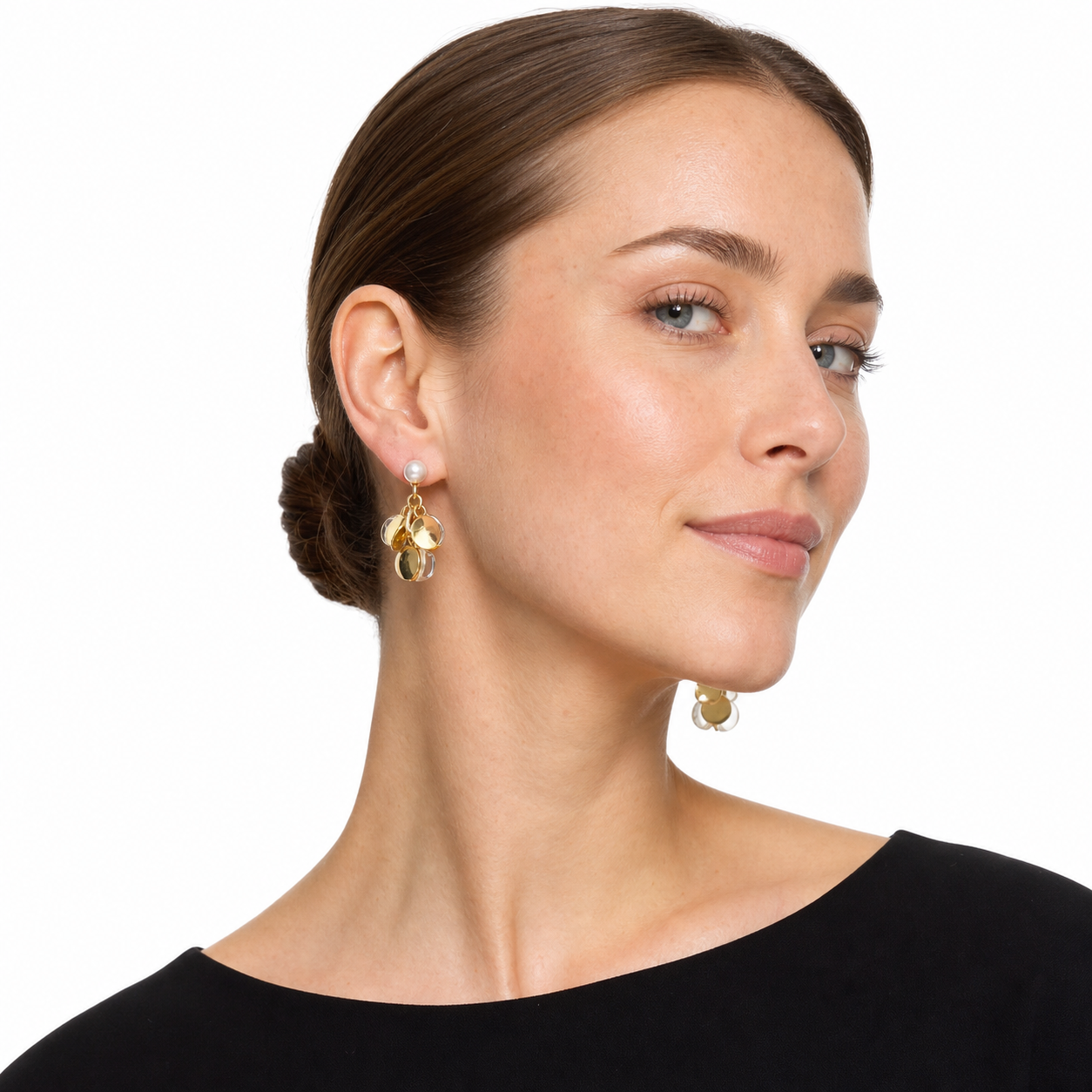 Western woman in a side-facing white-studio pose wearing modern pearl and clear cluster drop earrings.